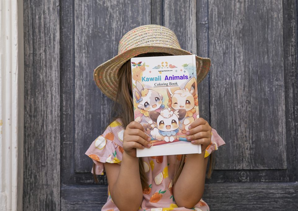 A child holding the Kawaii Animals Coloring Book